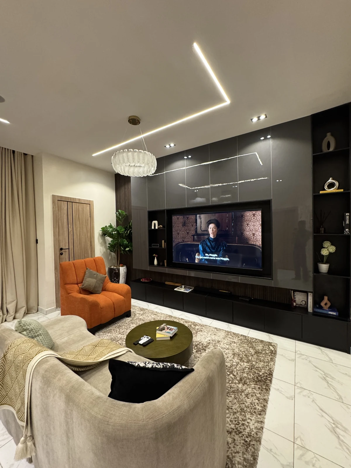 Veyra — living room with curved sofa and orange armchair, view 206