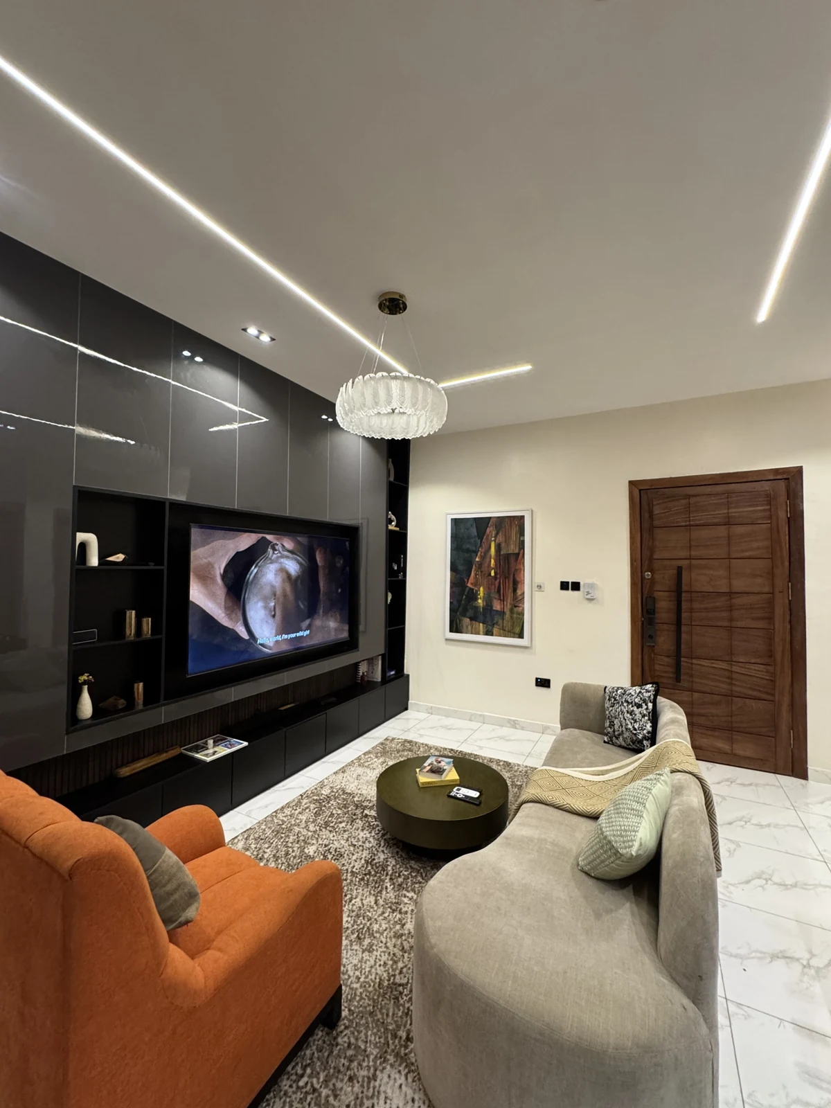 Veyra — living room with curved sofa and orange armchair, view 208