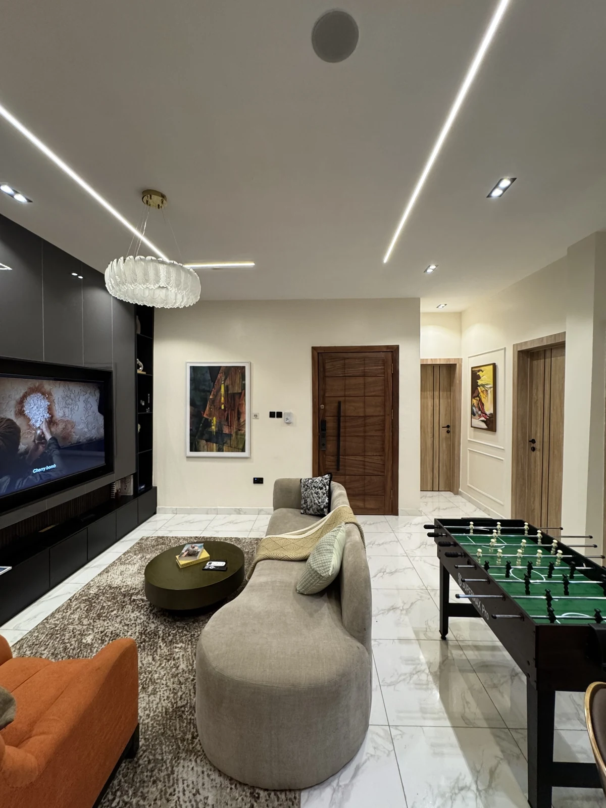 Veyra — living room with curved sofa and orange armchair, view 209