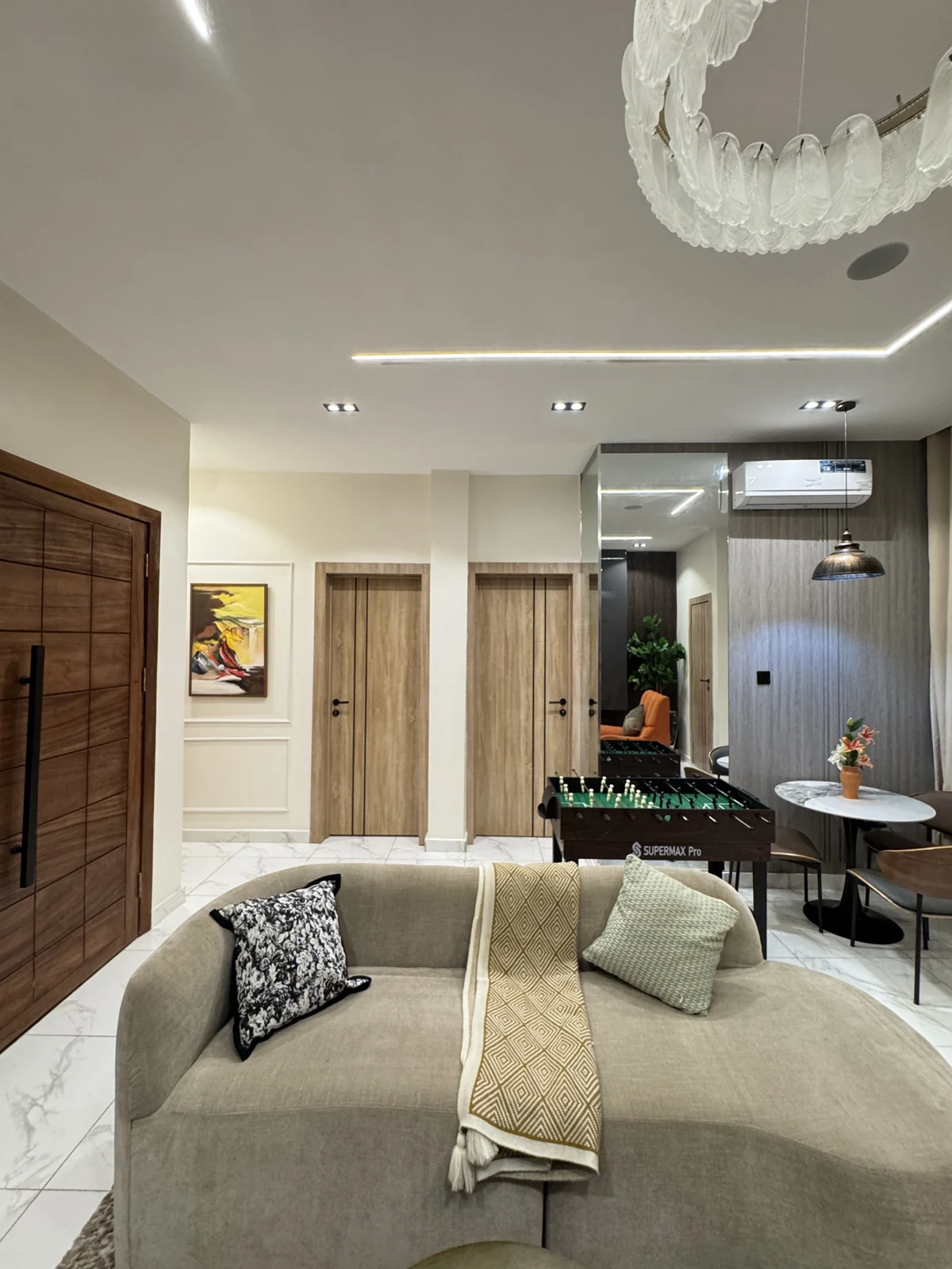 Veyra — living room with curved sofa and orange armchair, view 217