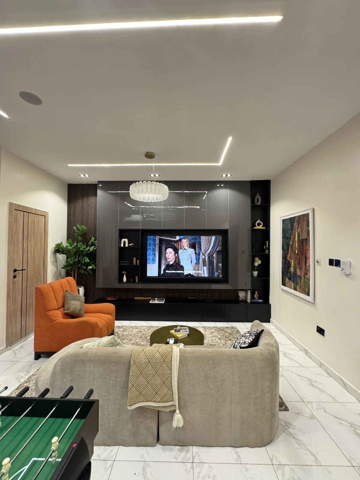Veyra — living room with curved sofa and orange armchair, view 221